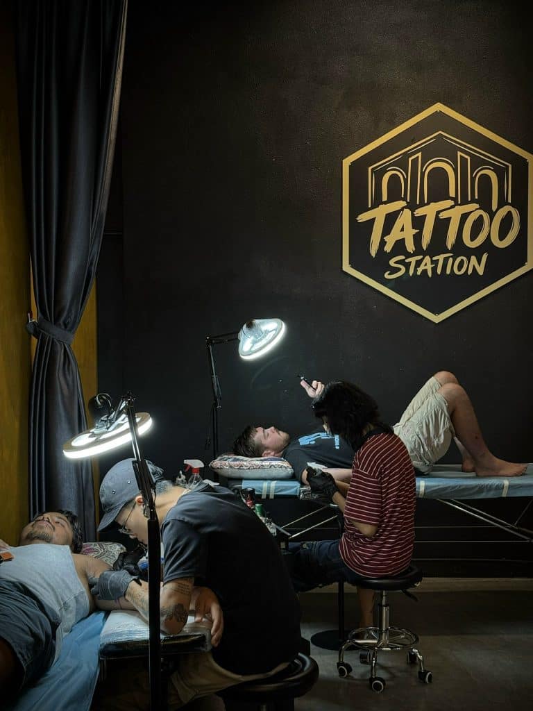 Tattoo artists working with international clients at Tattoo Station Hoi An