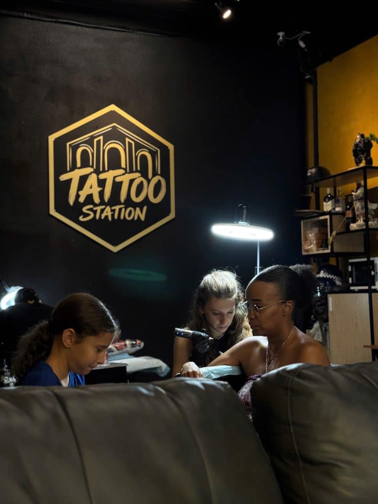 Custom tattoo session at Tattoo Station Hoi An with family waiting comfortably