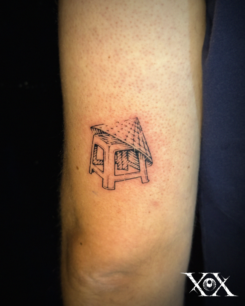 Vietnamese Tattoo featuring a Vietnamese plastic stool with a traditional conical hat, inspired by everyday street life in Vietnam