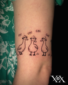 Vietnamese Tattoo featuring funny ducks wearing Vietnamese conical hats.