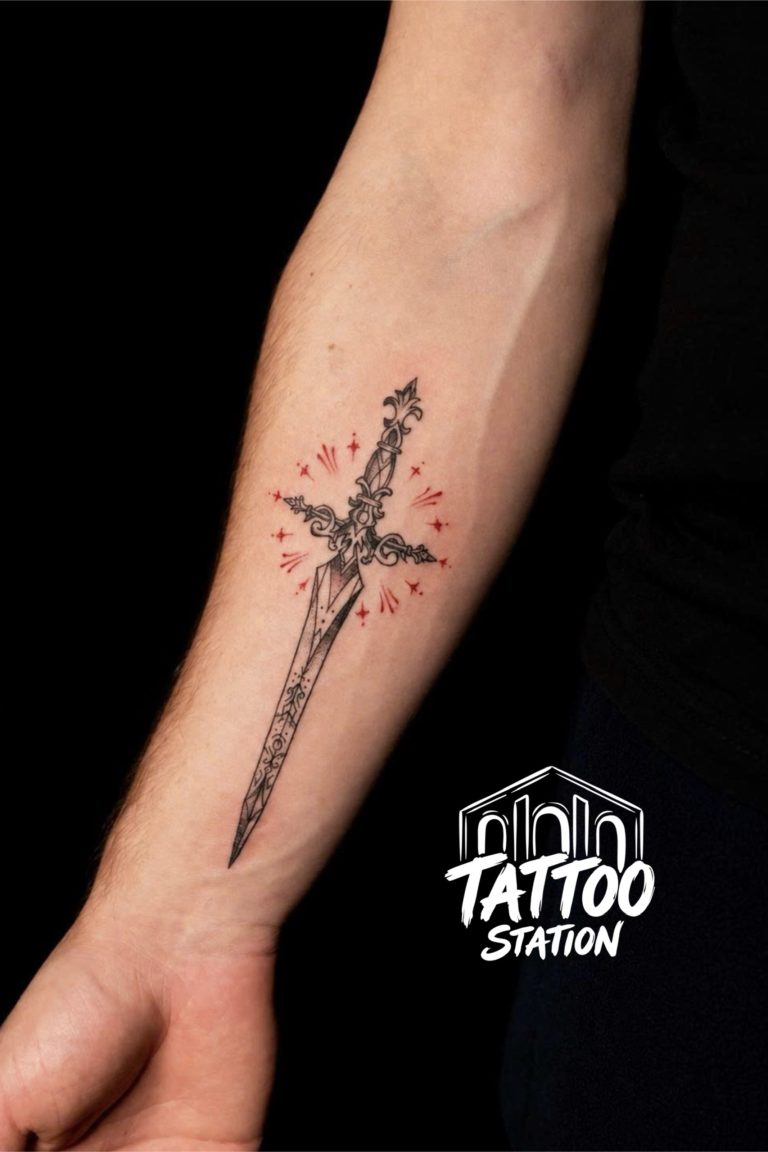Fine line ornamental dagger tattoo on inner forearm by Arina Kiwi at Tattoo Station Hoi An.